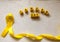 Golden ribbon and words made up of children`s plastic beeches. concept - a symbol of childhood cancer, pediatric oncology