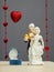 Golden ring in box for Valentines Day and porcelain figures of boy and girl