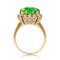 Golden ring with large emerald and cubic zirconias isolated