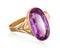 Golden ring with purple gemstone closeup