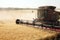 Golden ripe wheat being harvested in a wheat field.