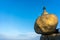 Golden rock or Kyaiktiyo pagoda with blue sky background, Myanmar