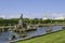 Golden Roman and Greek statues, playing fountains, green park and gardens at Grand Peterhof Palace at sunny day and blue sky,