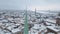 Golden rooster on one of spires of old city of Riga - Vecriga covered in snow