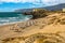 Golden sand beach with people resting in summer in the Atlantic sea. Lisbon