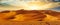 Golden Sand Dune Desert Landscape Panaroma. Beautiful sunset over the sand dunes in the Al Madam Desert.