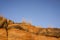 Golden sandstone cliffs lit by sunset