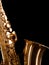 Golden saxophone on dark background.