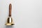 Golden school bell with wooden handle on grey background, top view. Space for text