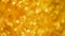Golden shiny background for Christmas greetings. Banner with defocused lights, bright yellow bokeh. Shimmer of gold