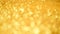 Golden shiny background for Christmas greetings. Banner with defocused lights, bright yellow bokeh. Shimmer of gold