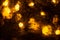 Golden shiny lights bokeh background. Yellow glittering blurred texture. Lights and bubbles abstract defocused background