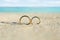 Golden And Shiny Wedding Rings On Beach