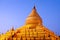 Golden Shwezigon Pagoda at sunrise in Bagan Archaeological zone, Myanmar