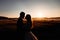 Golden silhouettes of wedding couple hugging