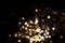 Golden and silver blurred bokeh lights on black background
