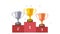 Golden, silver and bronze trophy cups on a podium pixel animation. 8 bit retro video game style.