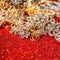 Golden and silver jewelry on red shiny glitter background