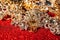 Golden and silver jewelry on red shiny glitter background