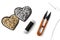 Golden and silver sequin heart patches, black thread, scissors and a needle