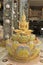 Golden sitting statue of Lord Buddha, sitting in a lotus, decorated with beautiful, colorful mosaic tiles at the entrance of at Ph
