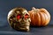 Golden skull with red eyes along with orange pumpkin