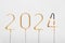 golden sparklers 2024 with burning number 4 on gray isolated background. New Year celebration concept and greeting idea