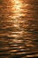 Golden sparkling morning sunlight reflections on the sea water surface with gentle ripples