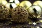 Golden sparkly Christmas balls on brown background. Magic holiday card. Christmas or New Year festive composition