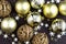 Golden sparkly Christmas balls on brown background. Magic holiday card. Christmas or New Year festive composition