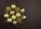 Golden sparkly Christmas balls on brown background. Magic holiday card. Christmas or New Year festive composition