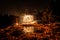 Golden sparks spray at night at stones rocks puddle reflects the sparks through glowing steel wool which is flung in a circle, Ger