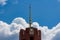 A golden spire over a building against a blue sky