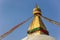 Golden spire and prayer flags at the Boudhanath stupa in Kathmandu