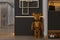 Golden Stainless Dog Statue placed in a foyer space, interior design