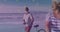 Golden star icons against african american senior couple with bicycle walking together at the beach