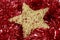 Golden star over a red garland. Christmas decoration