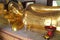 A golden statue of Buddha occupies one of the halls of a temple (Thailand)