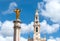 Golden statue of Christ and main tower of Fatima sanctuary