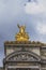 Golden statue on the frontal facade of Palais Garnier in Paris, France