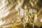 golden streamers transparent champagne glasses against blurred background. High quality photo