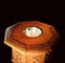 Golden sun shining on top of wooden baptismal font