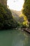 Golden sunrays illuminate a towering cliff in Wulong Karst, Chongqing, China