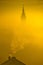 Golden sunrise church tower in fog