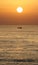 Golden sunrise in marbella, southern Spain with ocean and boat