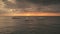 Golden sunset above ocean bay aerial. Sailing boats at sun set light. Nature seascape at summer