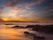 Golden sunset with clouds at Liencres beach