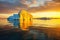 golden sunset highlighting iceberg surfaces in open ocean