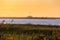 Golden sunset light above a long steel tied arch bridge - Robert Moses causeway