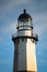 Golden sunset light hitting the side of a tall stone lighthouse. Montauk Point, NY